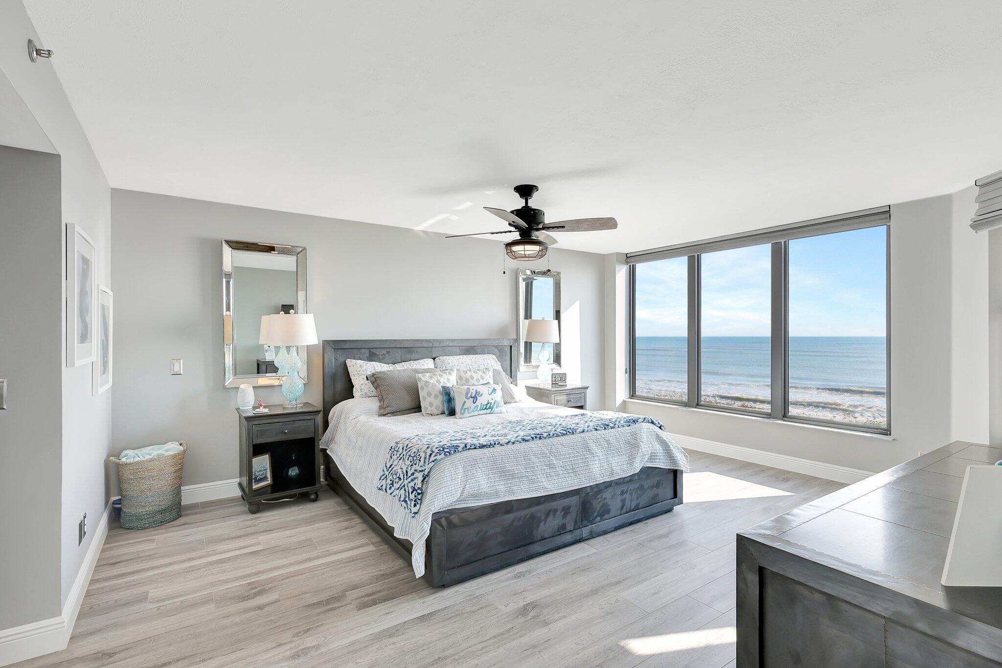 4000 North Hwy A1A, Unit 402 Hutchinson Island, FL 34949 - Photo 22 of 60 a bedroom with a large bed and a large window