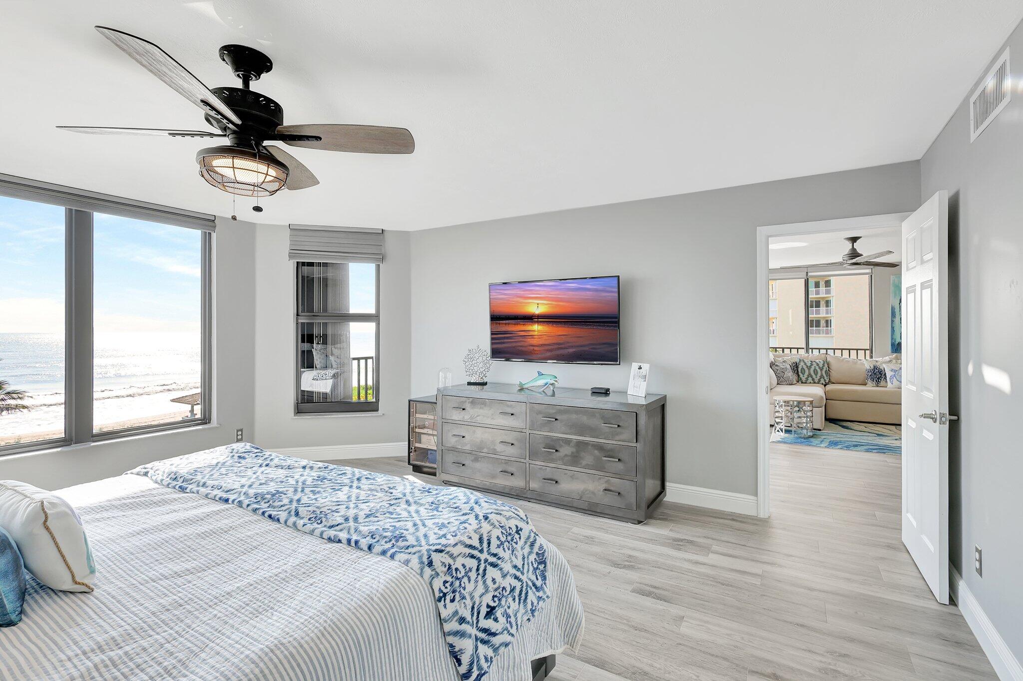 4000 North Hwy A1A, Unit 402 Hutchinson Island, FL 34949 - Photo 23 of 60 a bedroom with furniture and a flat screen tv