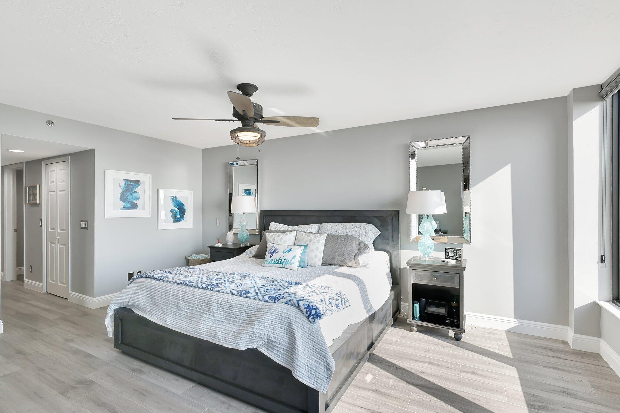 4000 North Hwy A1A, Unit 402 Hutchinson Island, FL 34949 - Photo 24 of 60 a bedroom with bed and a chandelier