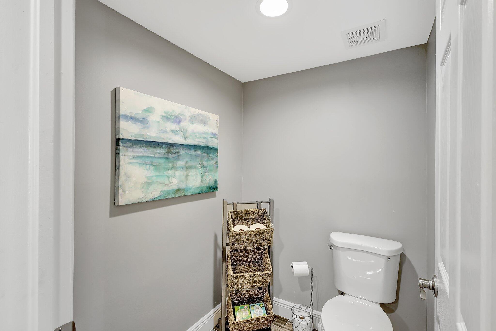 4000 North Hwy A1A, Unit 402 Hutchinson Island, FL 34949 - Photo 26 of 60 a white toilet sitting next to a bathroom sink