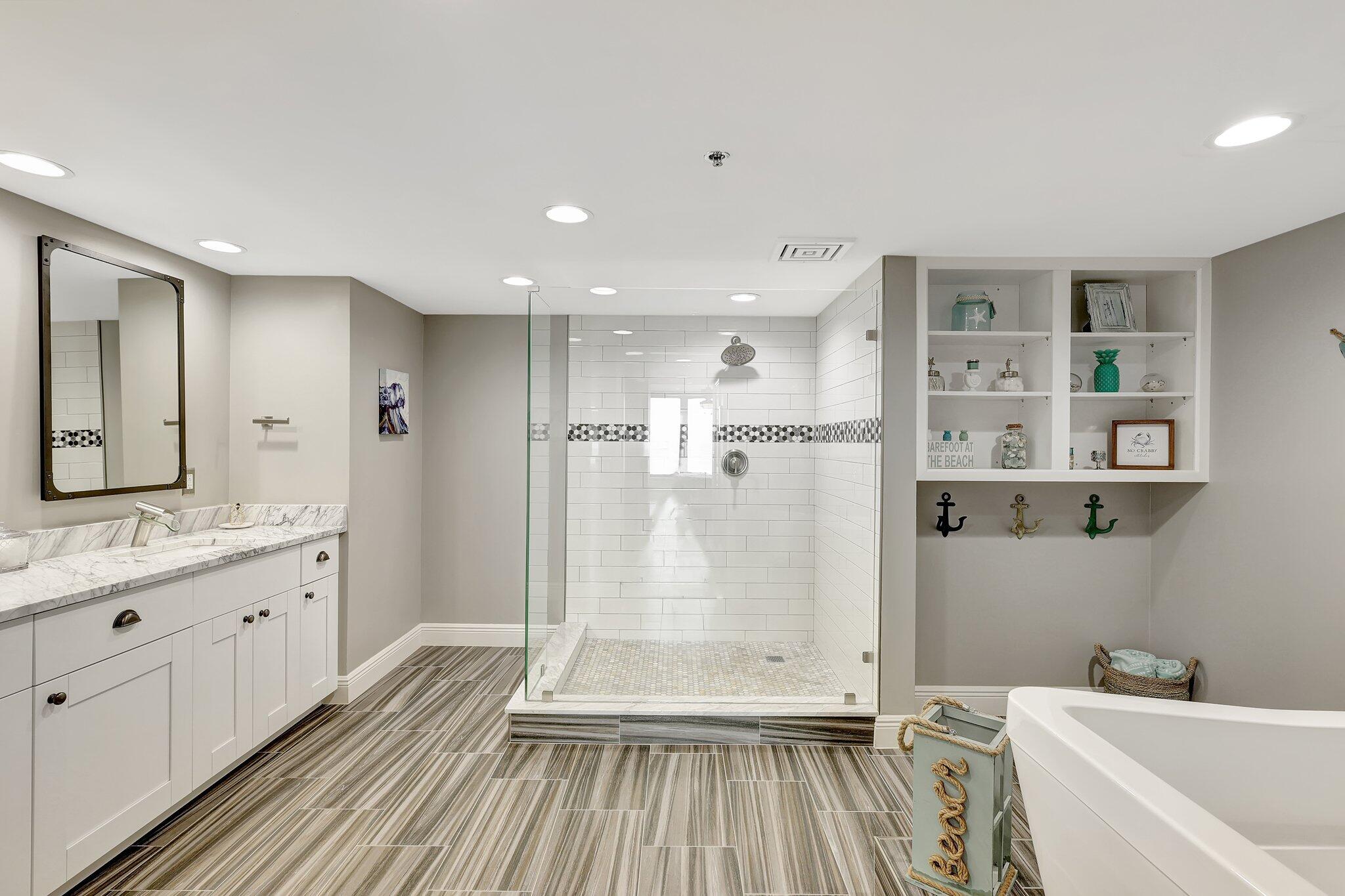 4000 North Hwy A1A, Unit 402 Hutchinson Island, FL 34949 - Photo 29 of 60 a bathroom with a double vanity sink toilet and shower