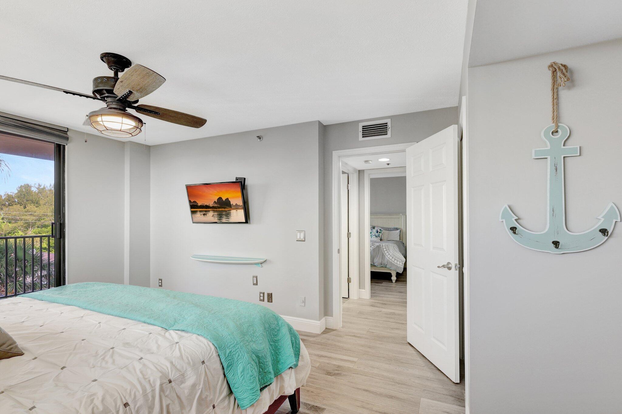 4000 North Hwy A1A, Unit 402 Hutchinson Island, FL 34949 - Photo 35 of 60 a bedroom with a bed and a chandelier