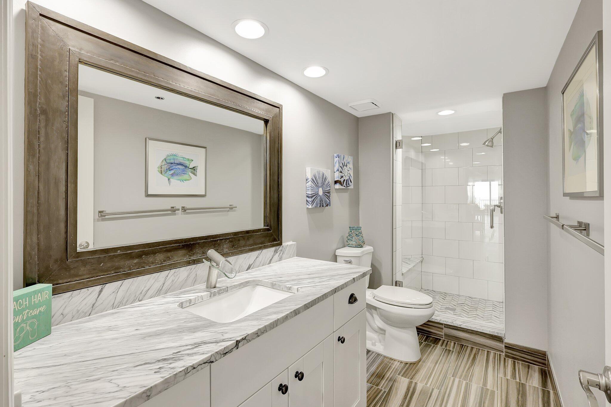 4000 North Hwy A1A, Unit 402 Hutchinson Island, FL 34949 - Photo 37 of 60 a bathroom with a sink a toilet and shower