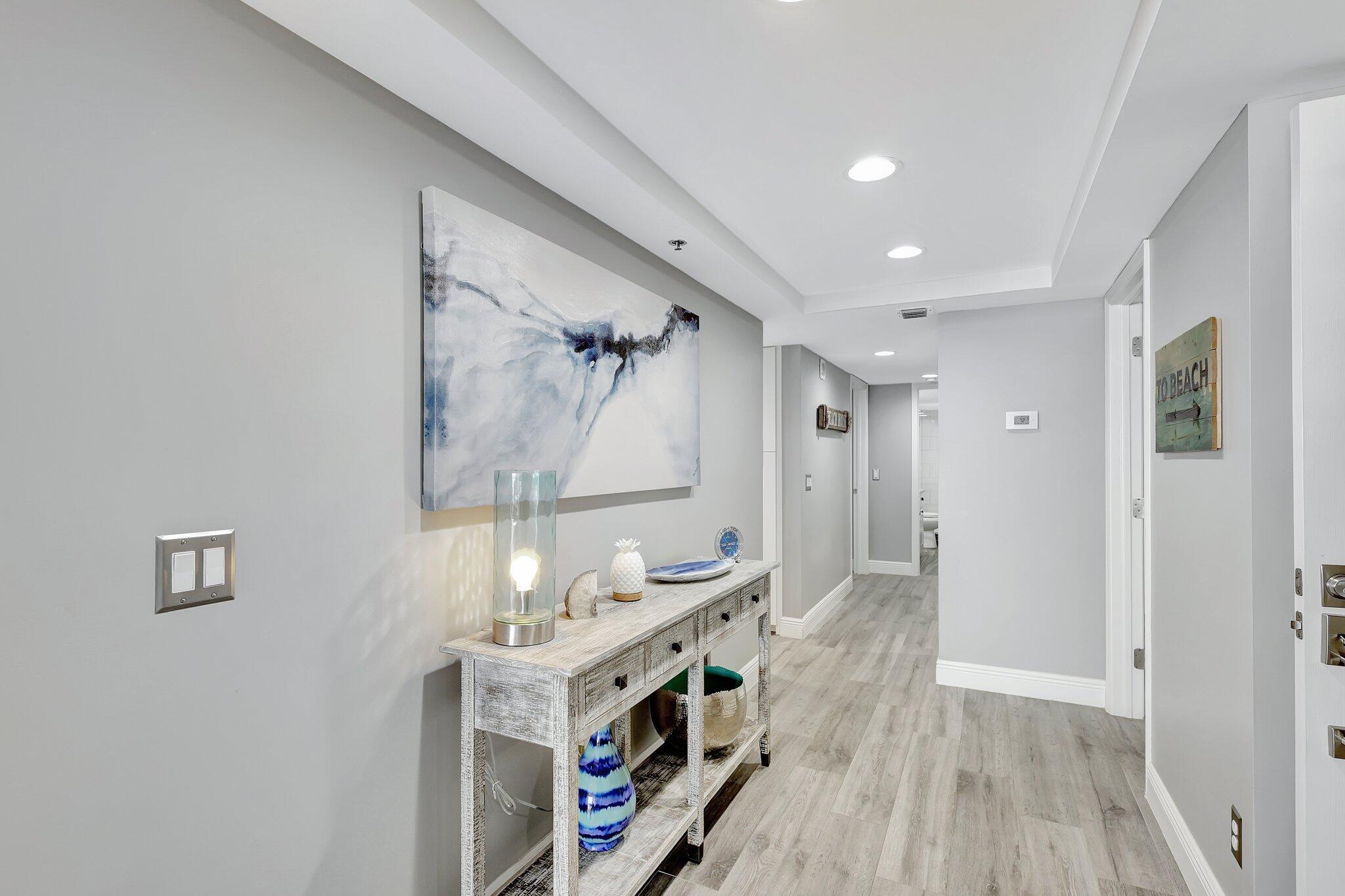 4000 North Hwy A1A, Unit 402 Hutchinson Island, FL 34949 - Photo 4 of 60 a spacious bathroom with a double vanity sink a mirror and a shower