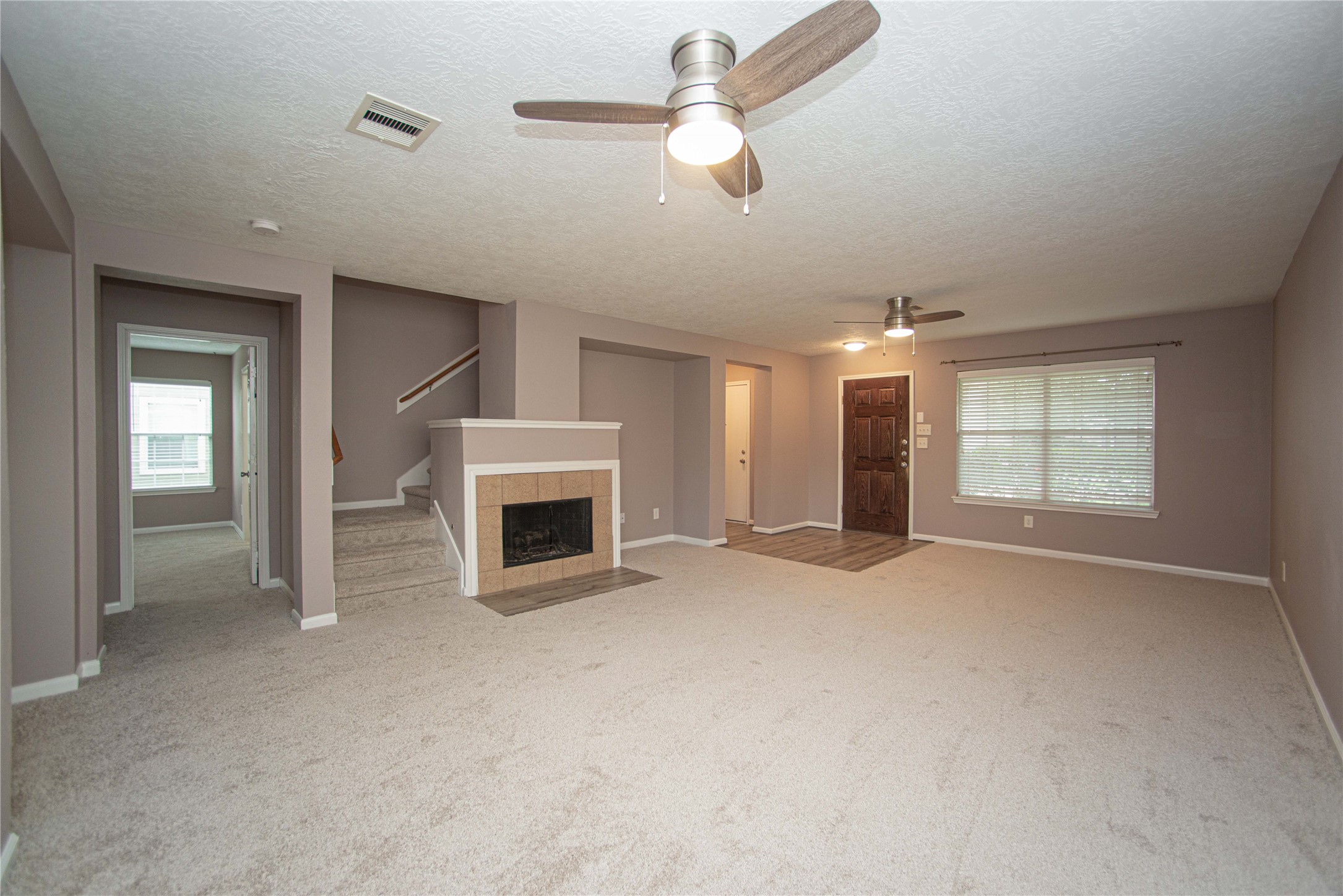 29314 Legends Bluff Drive Spring, TX 77386 - Photo 3 of 31 an empty room with windows and fireplace