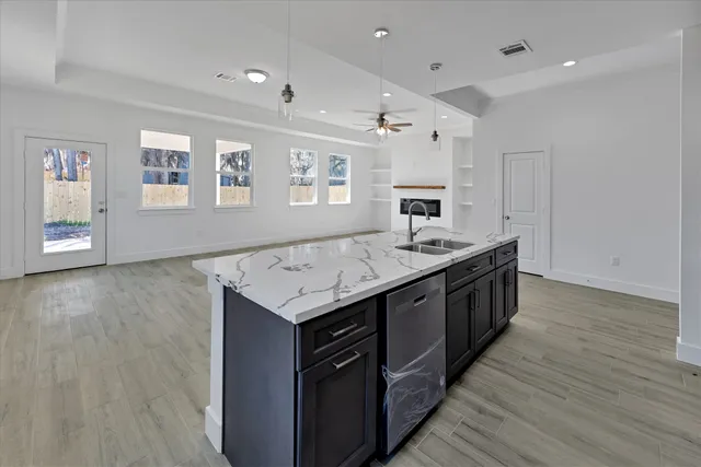 a kitchen with a sink stove and cabinets