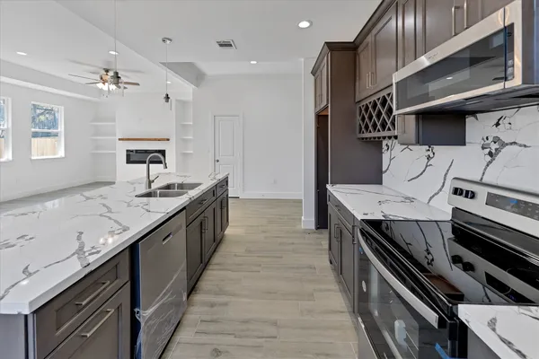 a large kitchen with a stove and a sink