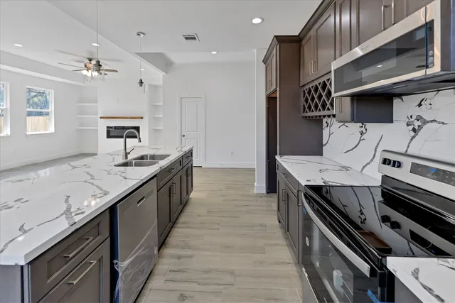 a large kitchen with a stove and a sink
