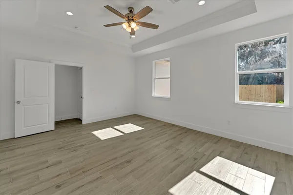wooden floor in an empty room with a window