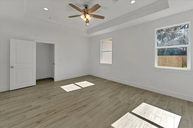 wooden floor in an empty room with a window