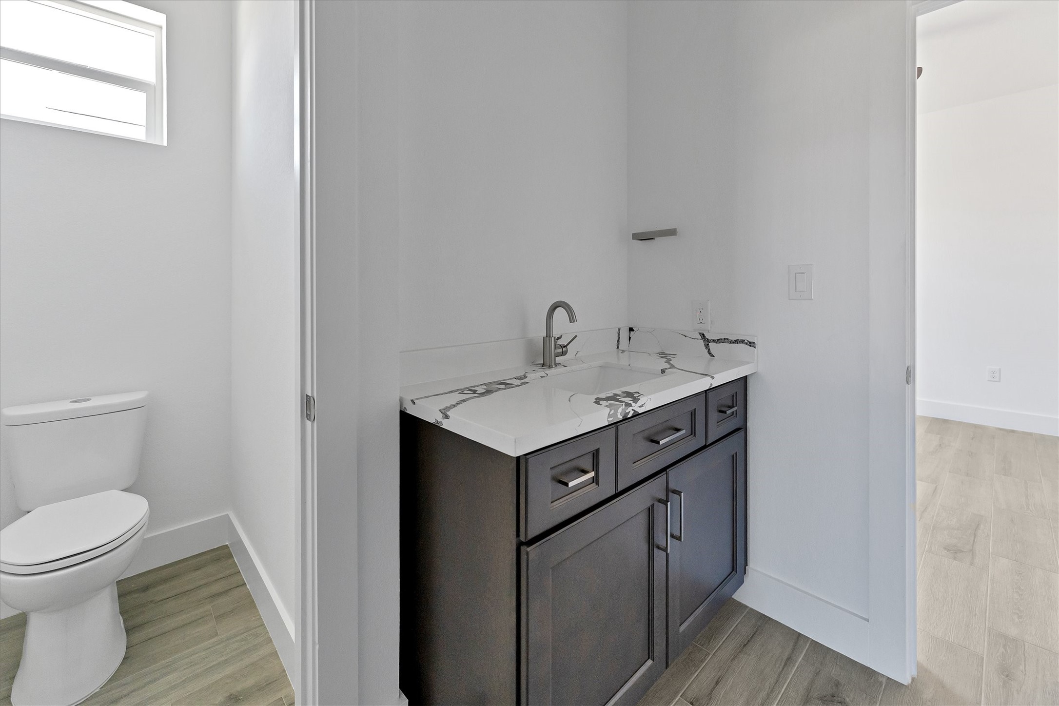 939 Lake View Drive Montgomery, TX 77356 - Photo 25 of 37 a utility room with sink toilet and wooden floor