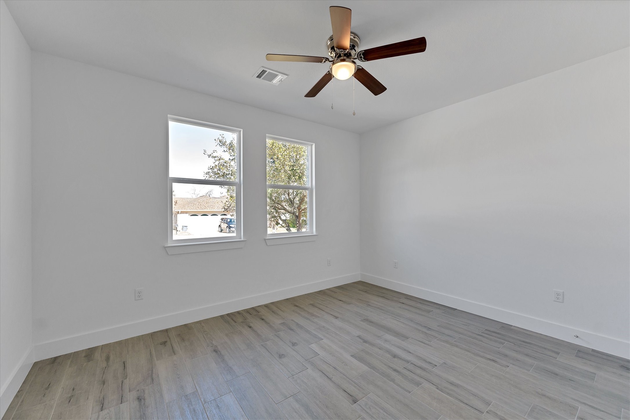 939 Lake View Drive Montgomery, TX 77356 - Photo 28 of 37 an empty room with wooden floor fan and windows