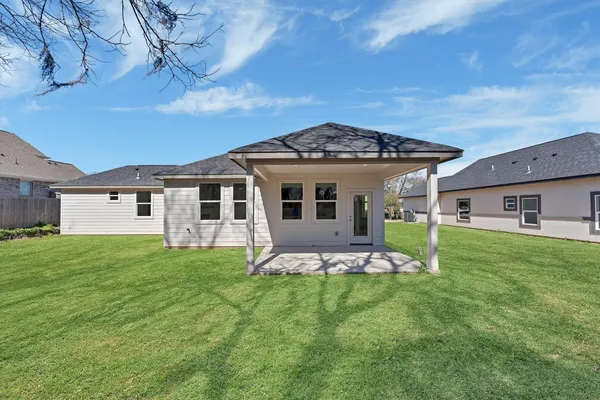 a front view of house with yard and green space
