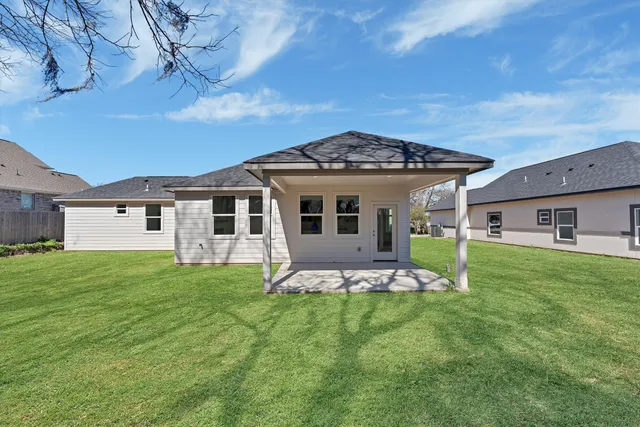 a front view of house with yard and green space
