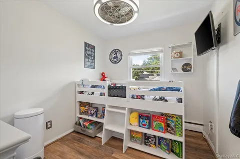 a room with furniture a flat screen tv and a window