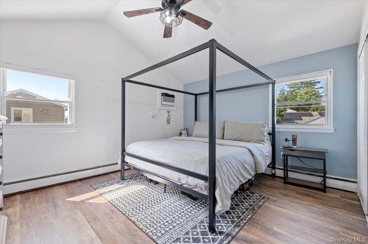 214 Haypath Road Old Bethpage, NY 11804 - Photo 20 of 27 a bedroom with a bed and a chandelier