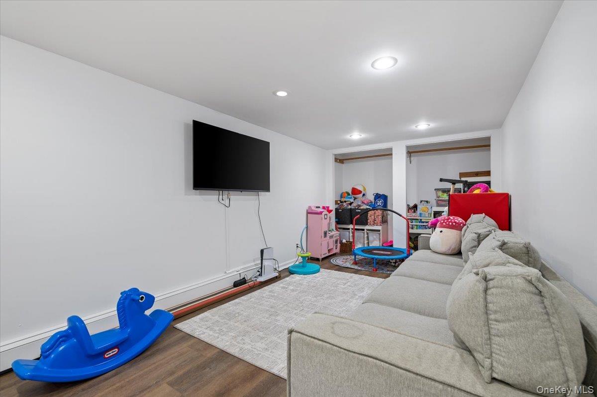 214 Haypath Road Old Bethpage, NY 11804 - Photo 21 of 27 a living room with furniture and a flat screen tv