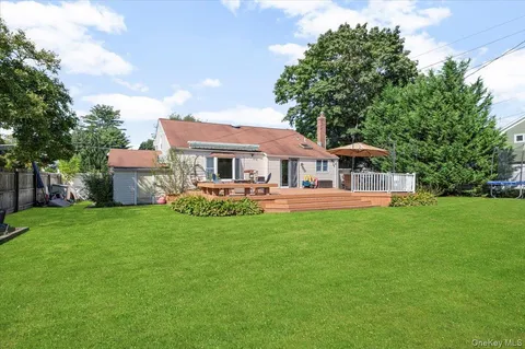 a front view of a house with yard and green space
