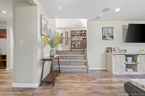 a view of a hallway with furniture and a potted plant
