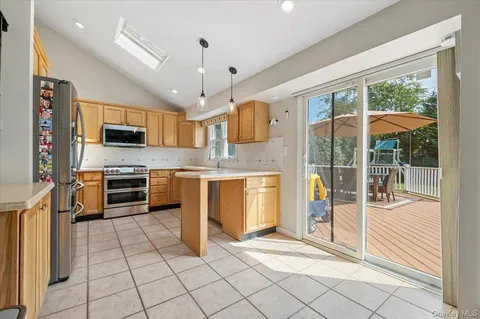 a kitchen with stainless steel appliances granite countertop a stove and a sink