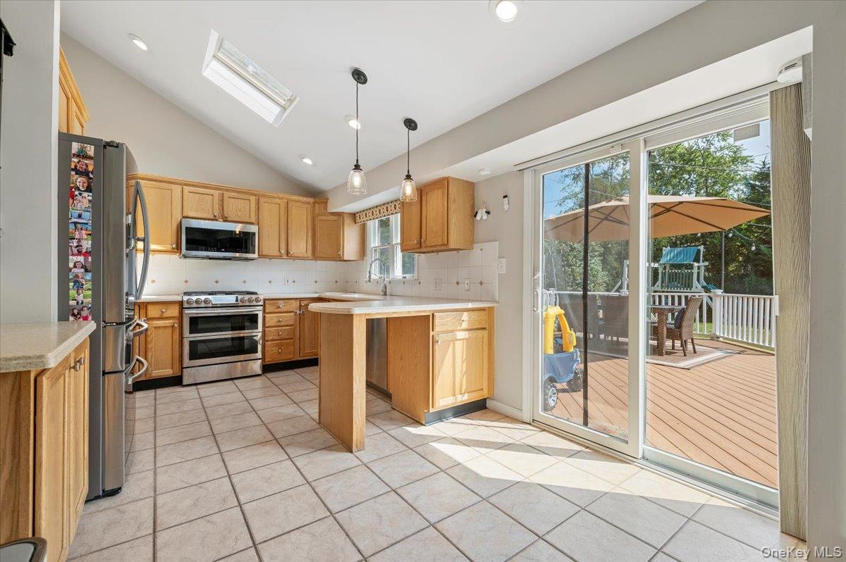 214 Haypath Road Old Bethpage, NY 11804 - Photo 8 of 27 a kitchen with stainless steel appliances granite countertop a stove and a sink