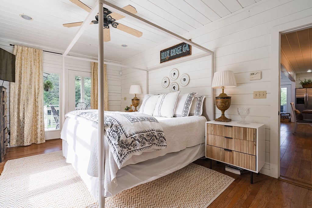 328 Black Ankle Creek Road Cherry Log, GA 30522 - Photo 18 of 103 a bedroom with a large bed and a chandelier
