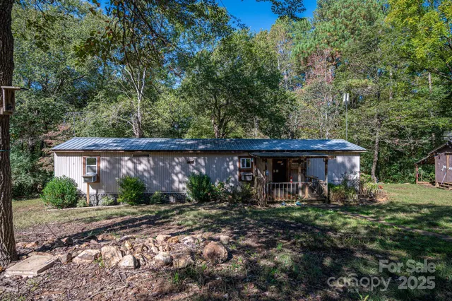 a view of a patio with table and chairs under an umbrella