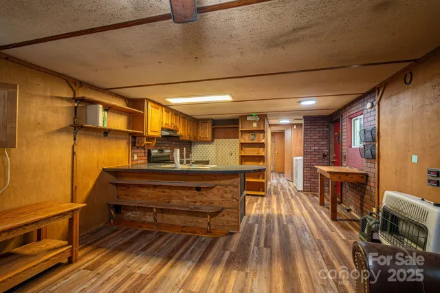 a sitting area with wooden floors and furniture