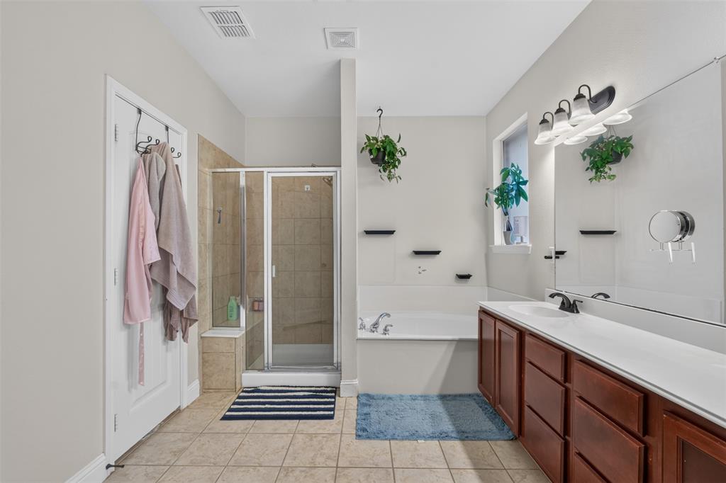 517 Austin Acre Road Sulphur Springs, TX 75482 - Photo 18 of 23 a bathroom with a double vanity sink and shower