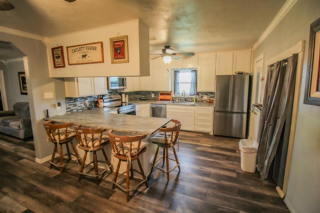 3061 Turkey Creek Road Sunset, TX 76270 - Photo 19 of 38 a kitchen with stainless steel appliances granite countertop a refrigerator and a stove top oven