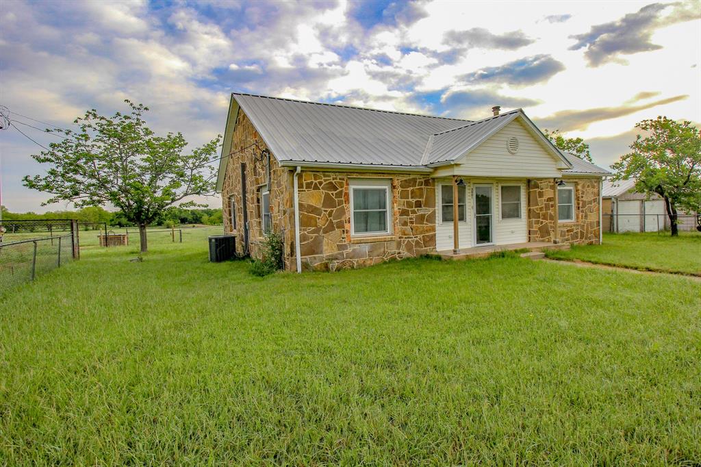 3061 Turkey Creek Road Sunset, TX 76270 - Photo 2 of 38 a view of a house with a garden