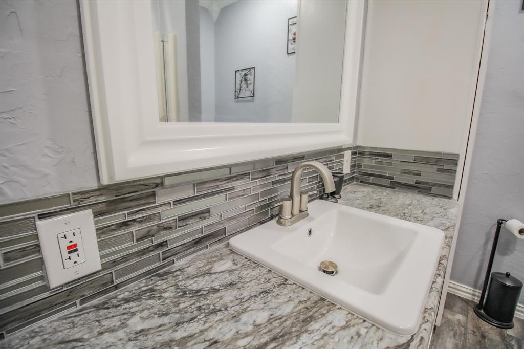 3061 Turkey Creek Road Sunset, TX 76270 - Photo 22 of 38 a bathroom with a sink and a mirror