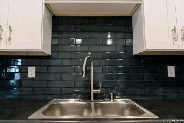 a kitchen with a sink and cabinets