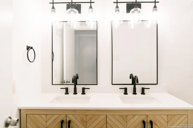 a bathroom with a double vanity sink and mirror