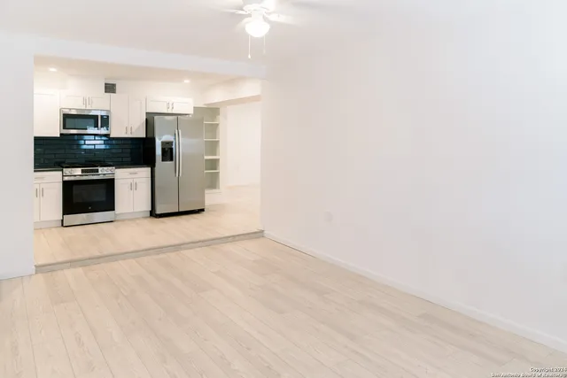 a view of kitchen with stainless steel appliances refrigerator and microwave