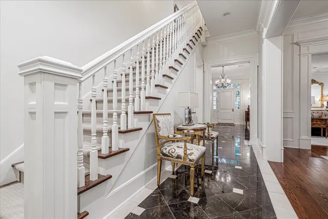 a view of hall way with furniture and wooden floor