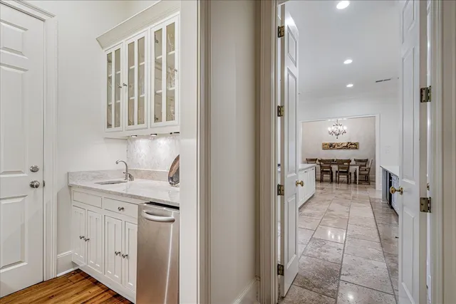 a en suite bathroom with a granite countertop sink and a mirror