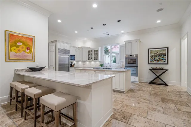 a kitchen with stainless steel appliances granite countertop a sink and a refrigerator