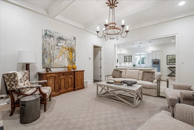 a living room with furniture and a chandelier