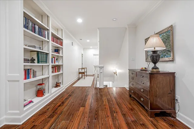 a view of living room with furniture and wooden floor