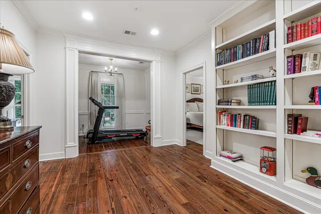 a hallway with cabinets and wooden floor