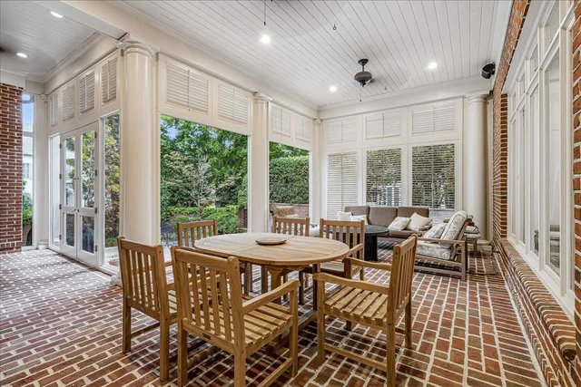 a view of a dining room with furniture large windows and wooden floor