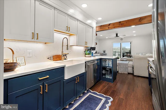 a kitchen with wooden floors appliances and cabinets