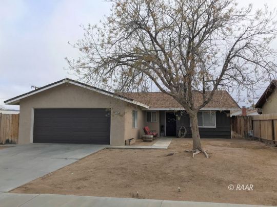 1237 West Iowa Avenue Ridgecrest, CA 93555 - Photo 1 of 20 a front view of a house with a yard and garage