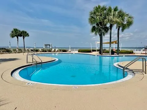 a swimming pool with outdoor seating and yard