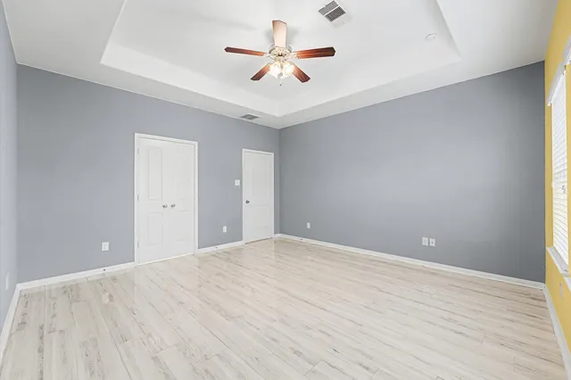 a view of a room with a ceiling fan