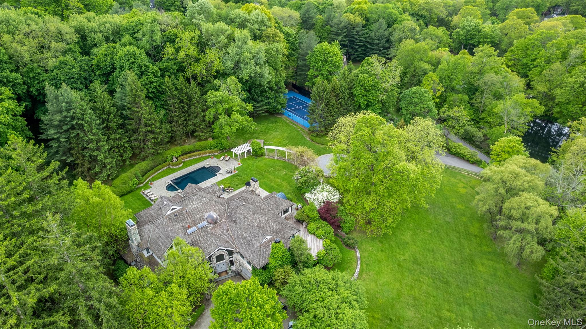 150 Old Farm Road North Chappaqua, NY 10514 - Photo 1 of 44 an aerial view of residential house with outdoor space and trees all around