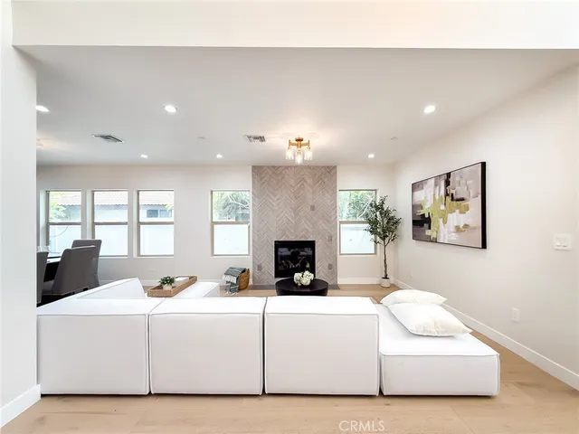 a view of a livingroom with furniture and floor to ceiling window