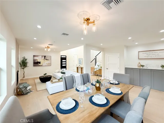 a large white room with a large window and furniture