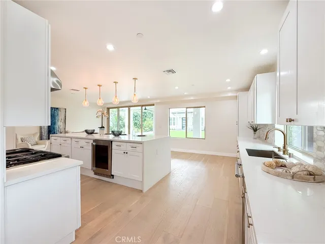 a view of empty room with wooden floor and window